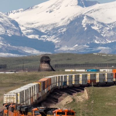 An intermodal train rounds bend outside of Glacier National Park